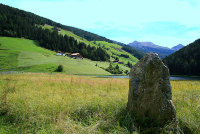 Scenic view of field and mountains against sky