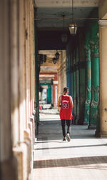 Full length rear view of man standing in building