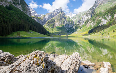 Scenic view of lake and mountains against sky