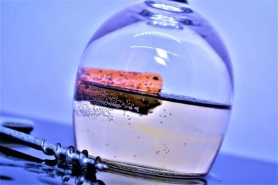 Close-up of glass against blue background