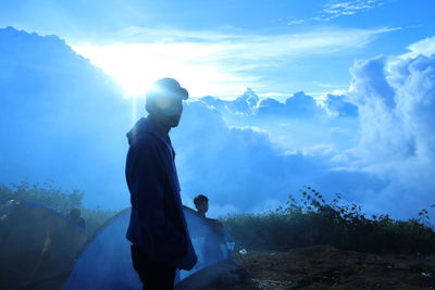 Man standing on mountain against sky