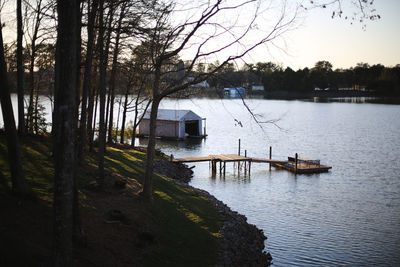 Scenic view of lake by building against sky