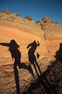 Shadow of women on rock formation