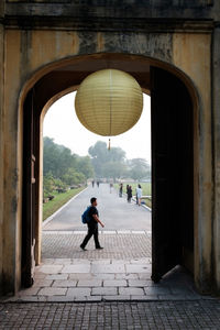 People walking on footpath in city