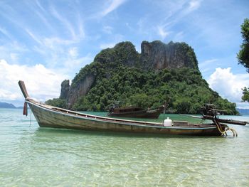 Boat moored on sea against sky