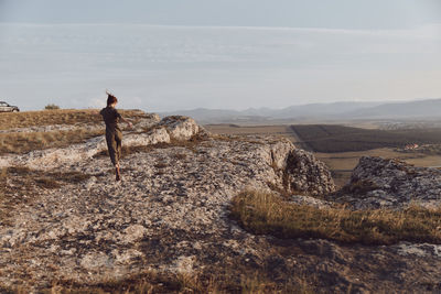 Rear view of man standing on rock