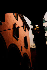 Low angle view of illuminated building against sky at night