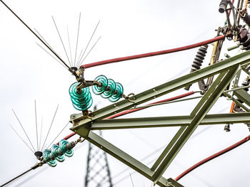 Low angle view of electricity pylon against clear sky