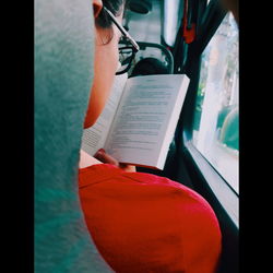 Midsection of woman reading book