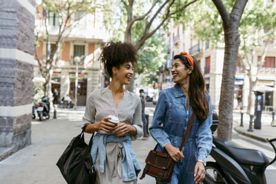 Young woman with text on sidewalk in city