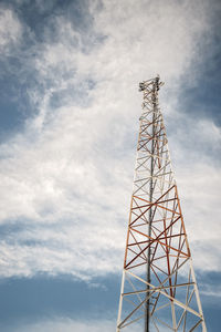 Low angle view of communications tower against sky