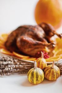 Close-up of roast chicken with orange slices in plate