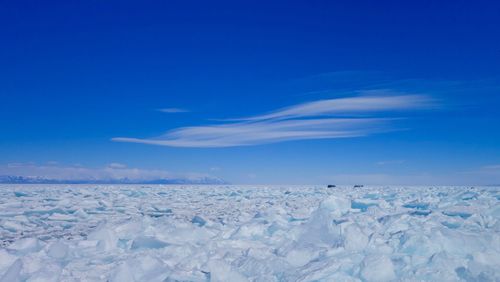 Scenic view of snow against blue sky