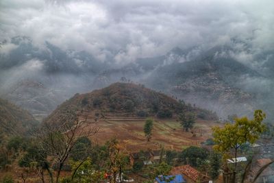 Scenic view of mountains against cloudy sky