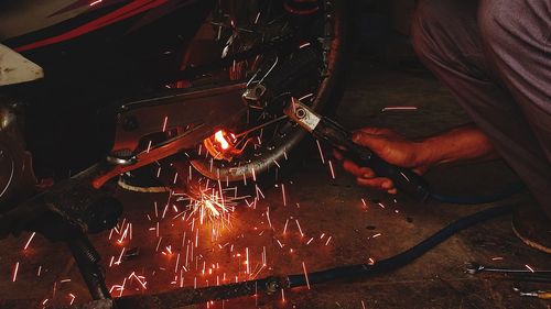 Cropped hand of man repairing car