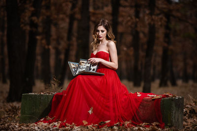 Portrait of woman with red umbrella