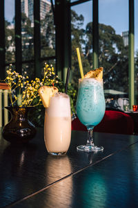 Tropical cocktails with pineapple and straw in glasses. pina colada. blue curacao. 