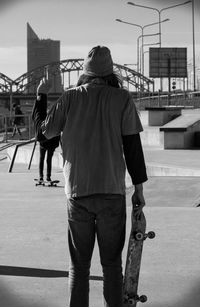Rear view of men standing in skate park