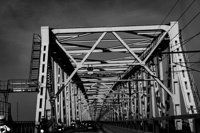 Low angle view of bridge and buildings against sky