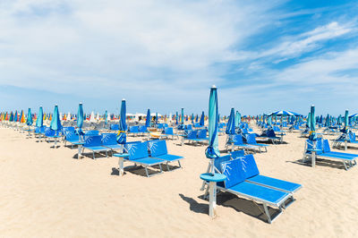 Beach on italian riviera with sunbeds and umbrellas enclosed