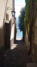 Walkway by sea against clear sky