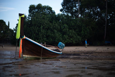 Boats moored on beach against sky