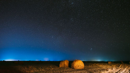 Scenic view of field against sky at night