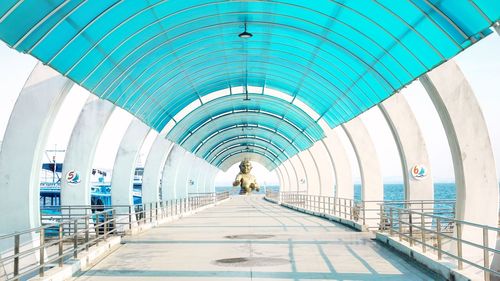 Rear view of people walking on elevated walkway