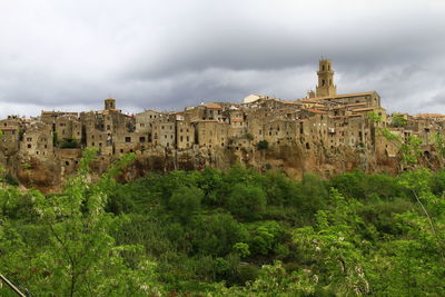 Built structures with trees in foreground