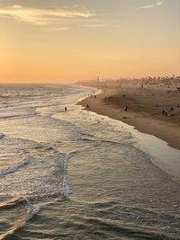 Scenic view of beach against sky during sunset