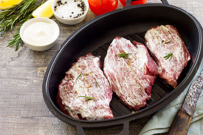 High angle view of meat in cooking pan on table