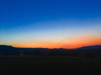 Scenic view of silhouette landscape against clear sky during sunset