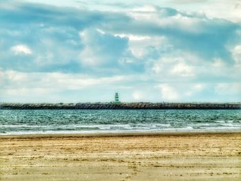 View of calm sea against cloudy sky