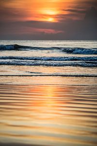 Scenic view of sea against romantic sky at sunset