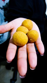 Close-up of hand holding fruits