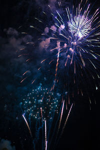 Low angle view of firework display at night