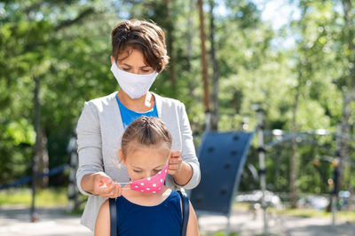 Father and boy wearing mask