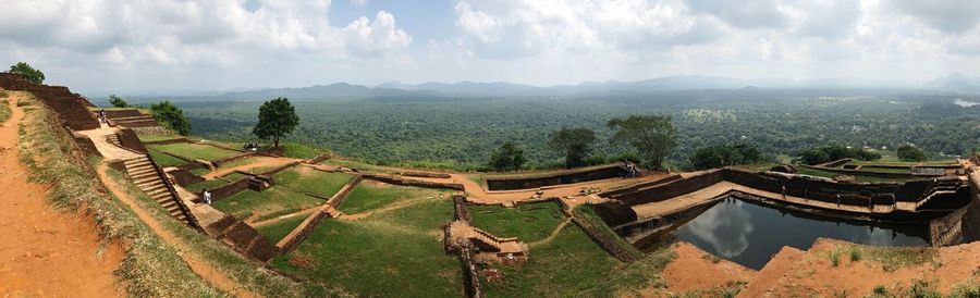 Panoramic view of green landscape against sky