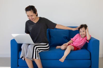 Woman sitting on sofa at home