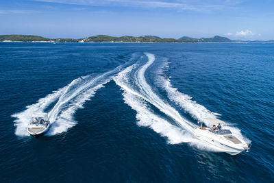 High angle view of boats in sea against sky