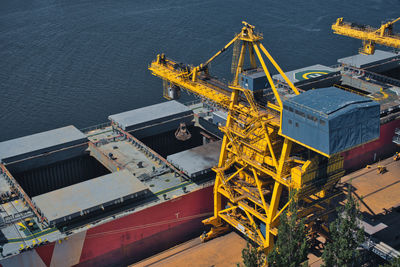 High angle view of illuminated commercial dock by sea