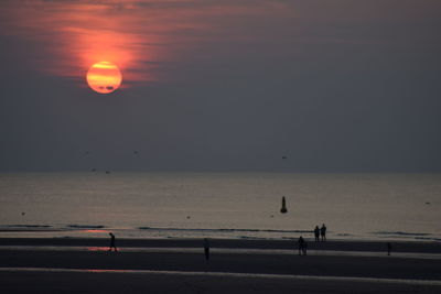 Scenic view of sea against orange sky