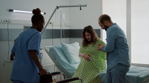 Couple with nurse at hospital