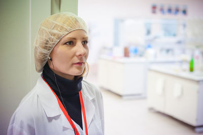 Female doctor wearing surgical cap while working in hospital