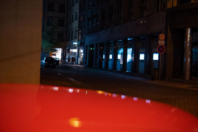 Reflection of illuminated building in city at night