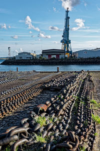 Close-up of chains on beach against sky