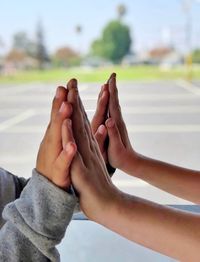 Midsection of couple holding hands outdoors