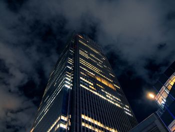 Low angle view of illuminated building against sky at night