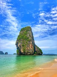 Rock formation in sea against sky