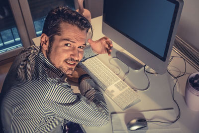 Portrait of businessman using computer in office